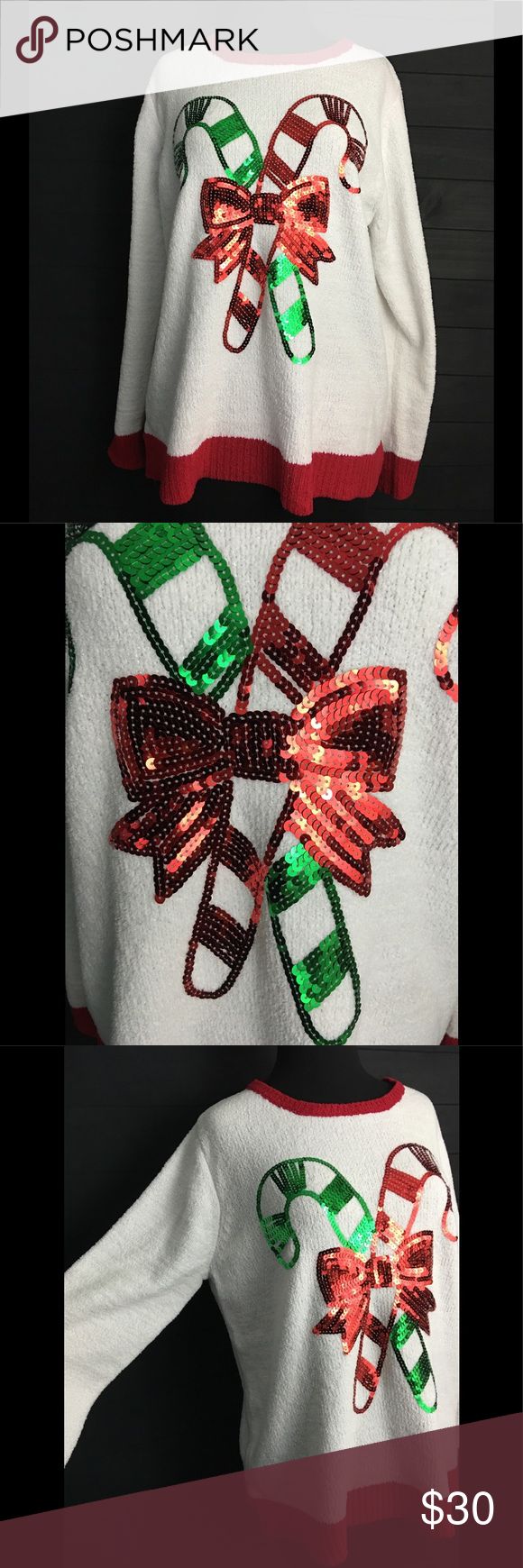 Christmas candy cane earrings with a holiday-themed sweater