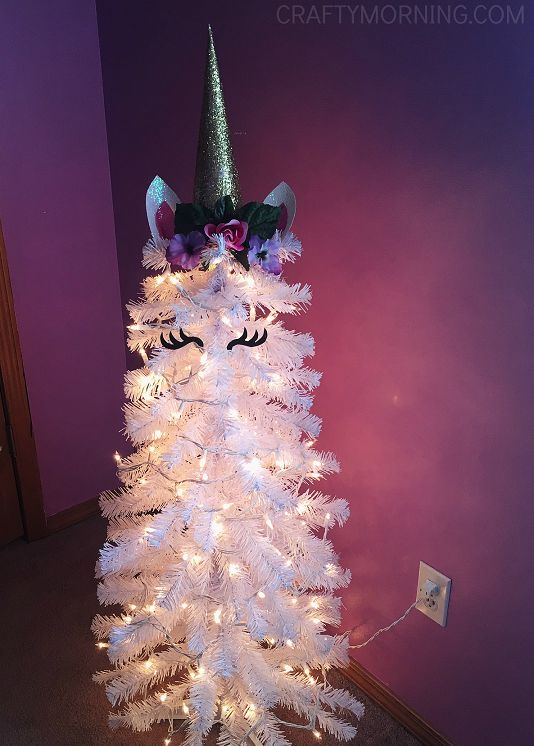 A glittering unicorn Christmas tree with a mix of glittering ornaments and a glittering tree topper